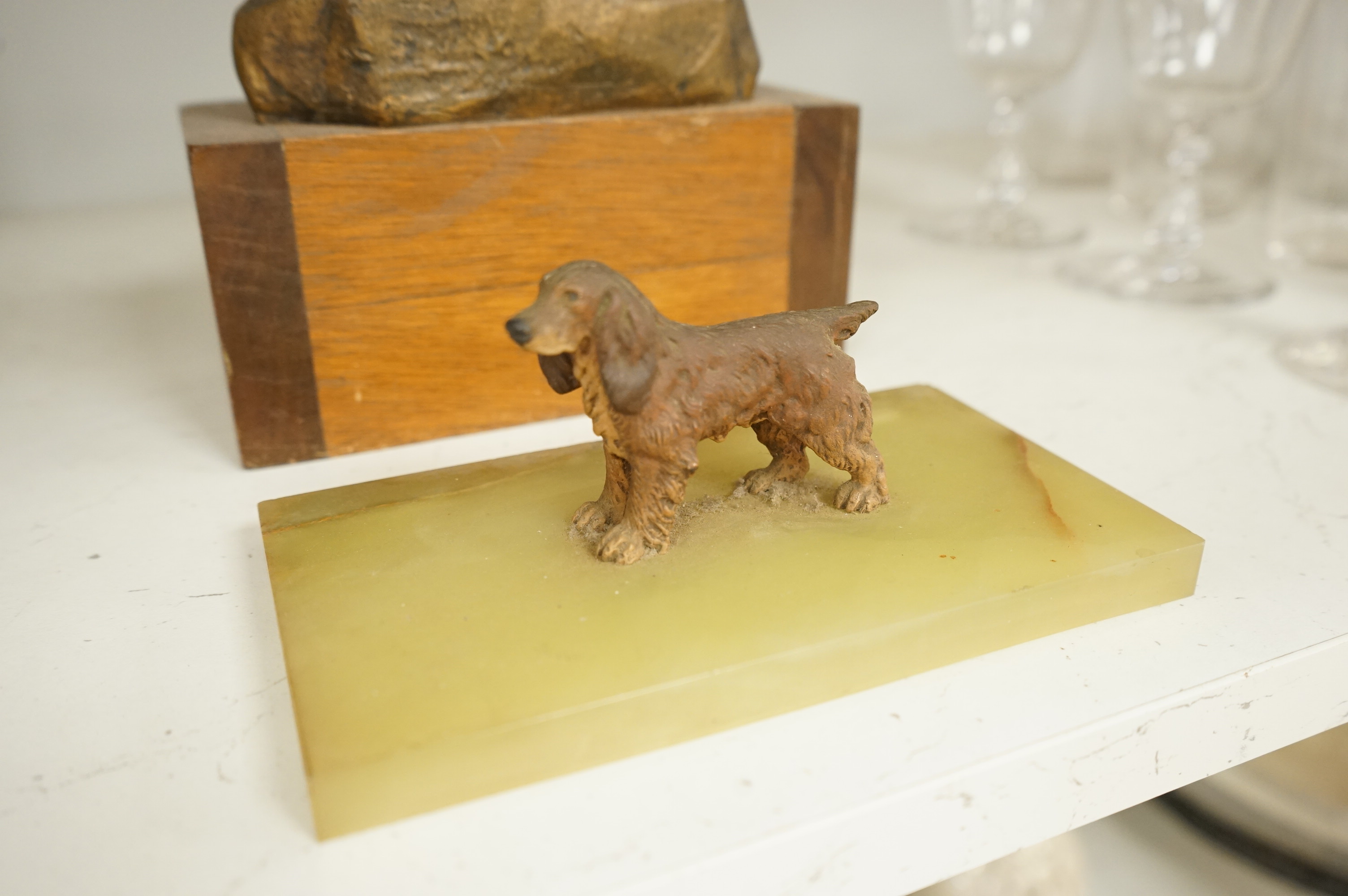 An abstract bronze model of a cow, 34cm and an Art Deco green onyx box, the lid surmounted with a cold painted bronze spaniel, 16.5cm wide.